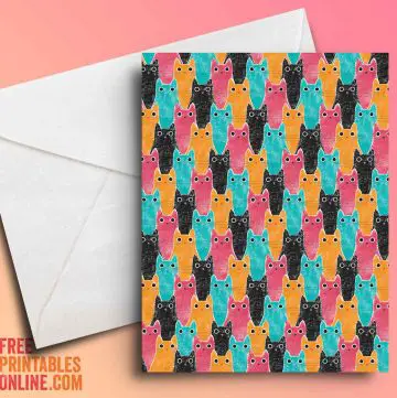 mockup image of a cat pattern greeting card. The cats are pink, orange, black, and blue.