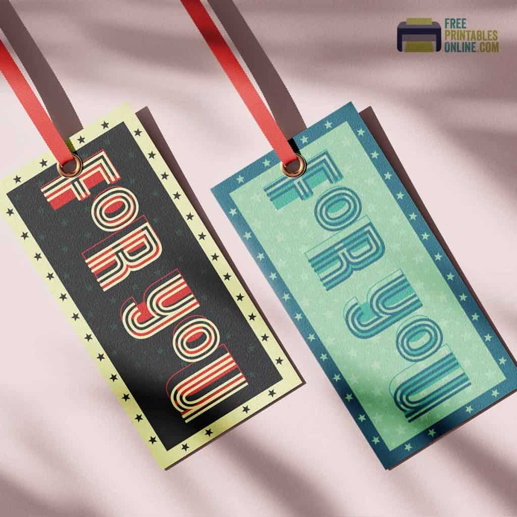 image consists of two gift tags slanting to the right as if hanging from above the line of the image. Both are fixed with red ribbons. Each tag contains the text "for you" and features a border of 5 point stars. The color scheme on one is blue and green and the other is red, black and yellow.