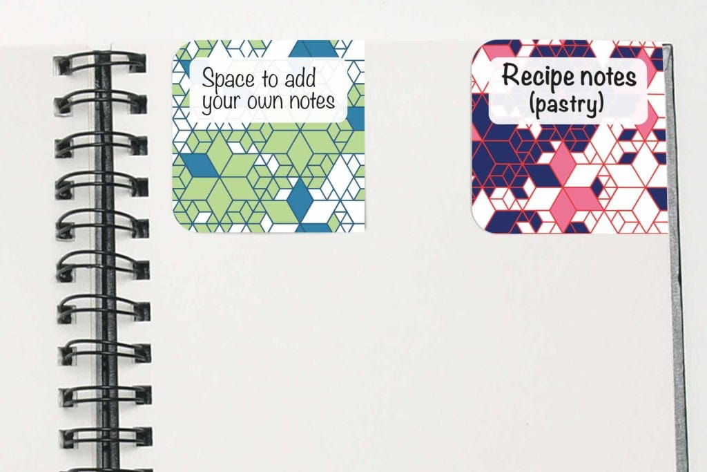 image of an open notebook with two print off bookmarks with geometrics patterns.